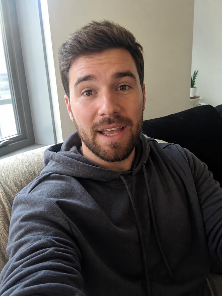 AI Twin example: Hoodie, sofa, arm's-length talking head.